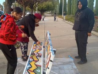 Volunteers painting bench.