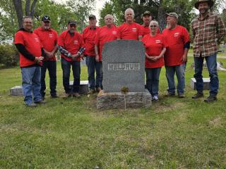 Volunteers placing veteran markers at gravesites.