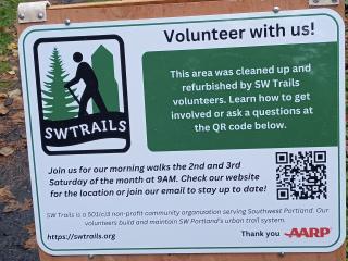 Trail sign with volunteer and walking opportunities.