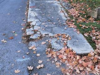 Crumbling sidewalk before repairs.