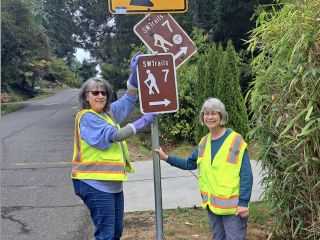 Volunteers replacing trail signs.