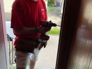 Volunteer installing new door.