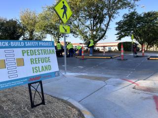 Work crew installing modular pedestrian island