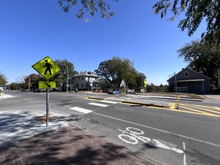 Completed intersection with new signage, crosswalk, and pedestrian island.