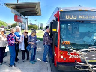 Older adults using a public transit bus.