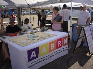 Table at community event with map of neighborhood and I-84.