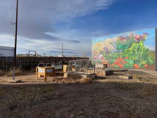 Raised garden beds and mural.