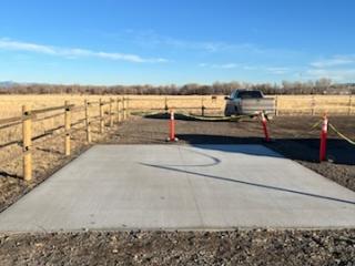 Concrete pad for future wheelchair charging station.