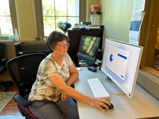 Older adult helping to install software for new computers