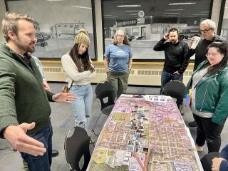 Group examining map of Fairview's bisected neighborhoods.