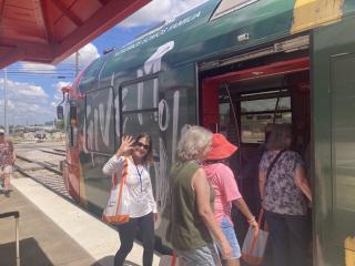 Older adults using a lightrail.