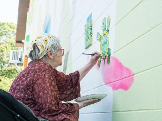 Volunteer painting mural.