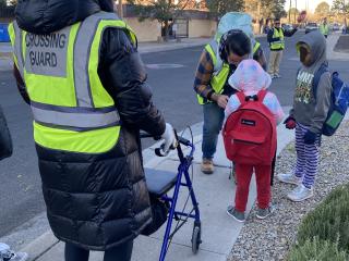 Older adult with rollator participating in Walking School Bus.