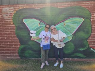 Community members in front of Luna Moth mural.