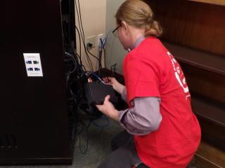 Installing adaptive listening system in library.