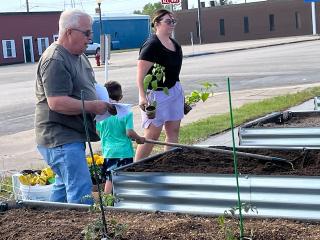 Volunteers planting garden beds.