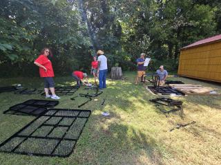 Volunteers assembling new picnic tables and benches.