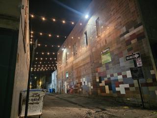 Lights in alley at night.