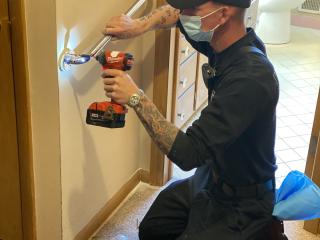 Fire Department member installing grab bar.