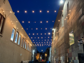 Lights in alley at night.