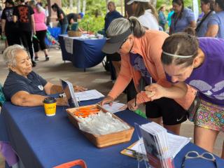 People completing survey at community event.