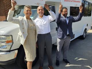 Holding an AARP sign in front of the Seabury bus.