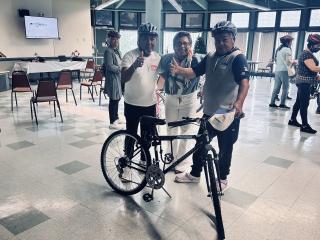 Older adults selecting bikes and helmets.