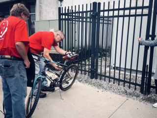 Volunteer mechanic adjusting bike