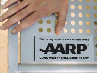 AARP sign on bench.