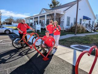 Adults installing bike racks in shape of a heart.