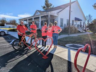 Adults installing bike racks in shape of a heart.