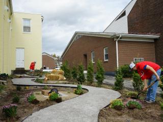 Planting flowers along the garden path