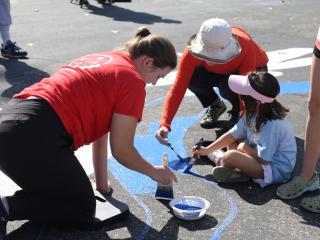 Painting a street mural.