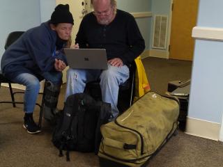 Two older adults voting for a housing design.