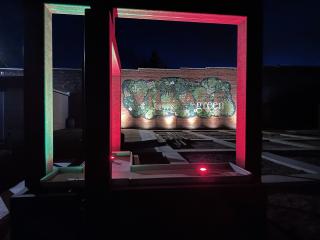 Colored lights illuminate water feature.