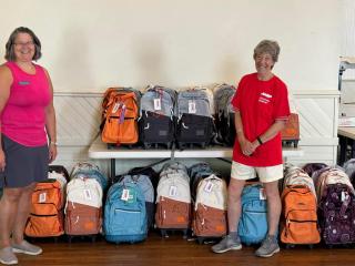 Staff with backpacks with disaster response supplies.