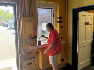 Volunteers painting interior.