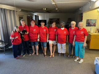 Group of residents in common room with new HVAC unit.