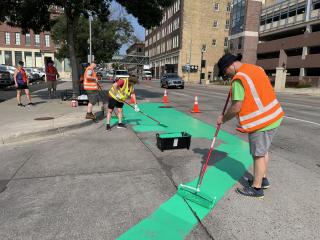 Volunteers painting bump-outs for traffic calming.