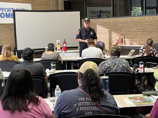 Attendees listen to fire department personnel discuss home safety.