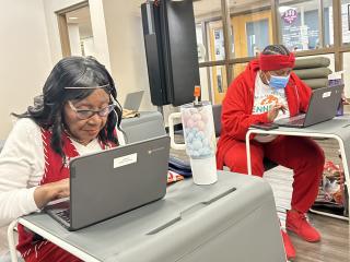 Two older adult attendees at digital literacy training.