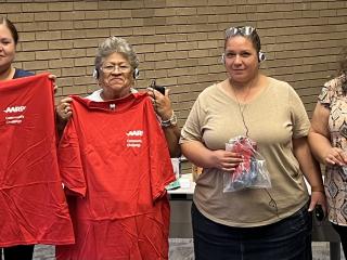 Training attendees holding home improvement items.