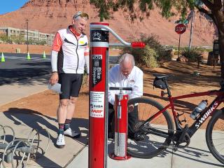 Older adult using bike pump.