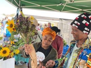 Selling flowers at farmers market.