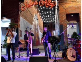 Band playing in front of alley and new Mount Airy lighted sign.