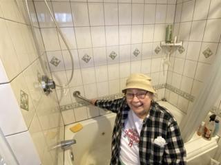 Older Adult with new grab bar in bathroom.