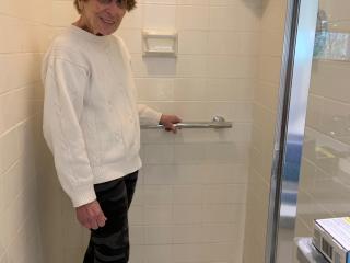 Older Adult with new grab bar in bathroom.