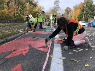 Volunteers painting the bike lane.