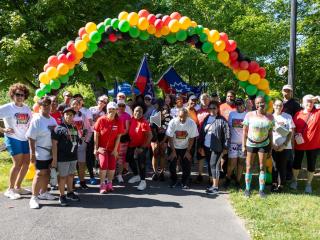 Group of volunteers under a balloon arch preparing to conduct a walk audit.