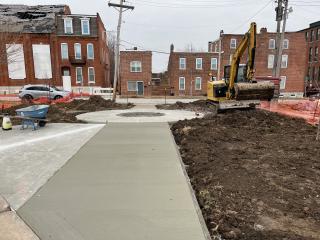 New sidewalk at transit stop under construction.